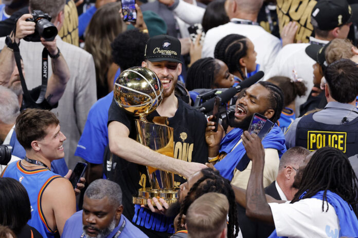 Chet Holmgren’s teammates save the Larry O’Brien trophy from damage as center staggers drunkenly on stage